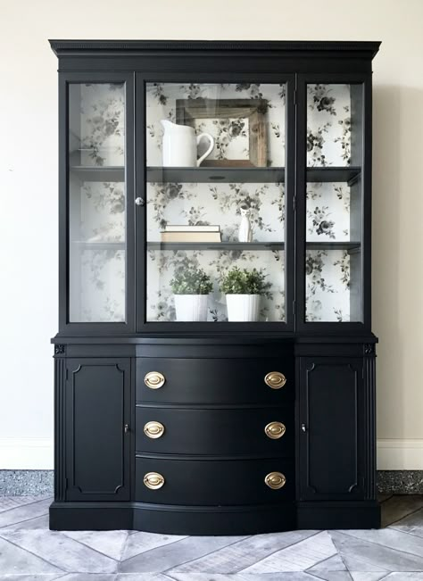 There is nothing better than a classic black. Lamp Black transformed this dated china cabinet into something both timeless and modern. Queenstown Gray was used to accent the interior. The china cabinet back was lined in a fabulous Magnolia Home wallpaper. The original Hepplewhite pulls were updated to an Antique Gold color. Simply stunning! Black China Cabinet, China Cabinet Makeover, Painted China Cabinets, Redo Cabinets, Hutch Makeover, Black China, China Hutch, Furniture Flip, Furniture Rehab