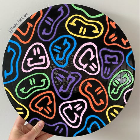 A 12 inch vinyl record with rainbow wiggle smiley faces painted on top. Painted Records Vinyl, Painted Vinyl Record, Vinyl Record Art Ideas, Painted Records, Painted Vinyl Records, Small Business Gift Ideas, Vinyl Art Paint, Hippie Crafts, Record Painting