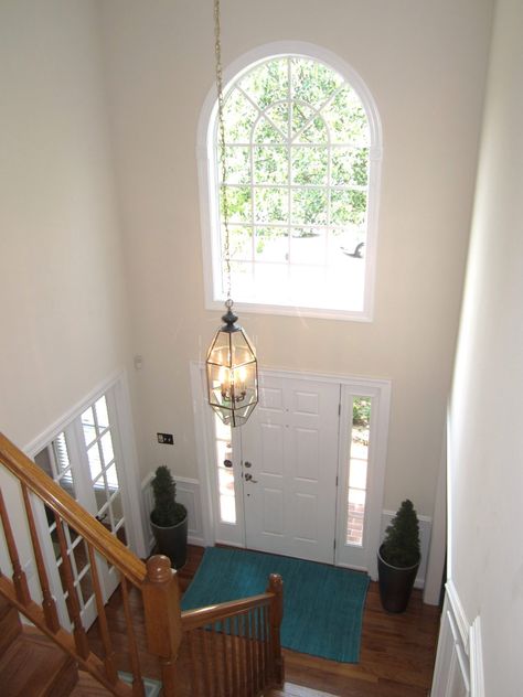 90s Entryway Makeover, Staircase At Front Door Entryway, Foyer With High Ceiling Entrance, Tall Entry Way Ideas, Colonial Entryway Foyers, High Ceiling Entryway Ideas, Chandelier Foyer Entryway High Ceiling, High Ceiling Foyer Ideas Entryway, Tall Foyer Ideas Entryway