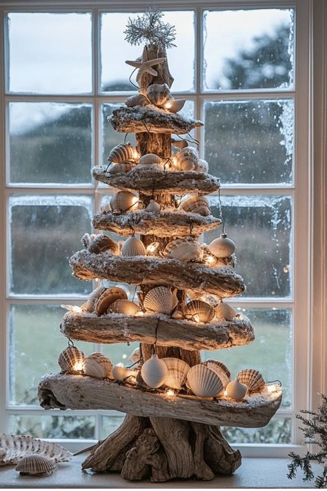 Who says Christmas can't have a beach vibe? Learn how to incorporate coastal elements into your holiday decor for a unique and refreshing take on Christmas. From seashell ornaments to driftwood trees, get inspired! Some of the links in my articles are affiliate links. If you make a qualified purchase from one of my links I will make a small commission at no cost to you. Thank you for your support!!! Driftwood Christmas Tree Decoration, Beachwood Christmas Tree, Xmas Driftwood Ideas, Nautical Christmas Decorations, Blue Beach Christmas Decor, Beach Xmas Decorations, Marine Christmas Tree, Palm Tree Christmas Tree, Seaside Christmas Decor