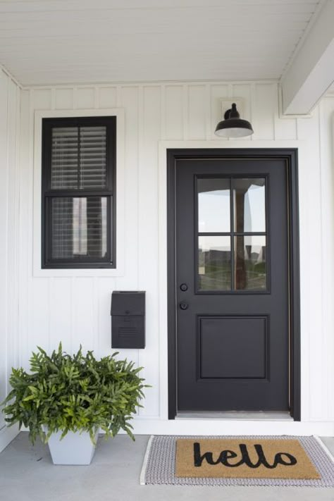 Greet guests to your home with style by installing a gooseneck barn light above the door! Black Farmhouse Door Exterior, Black Shutters Colored Front Door, Exterior Door Colors For White House, Closed In Garage Ideas Exterior, Black Matte Front Door, Front Entryway Doors, Farmhouse Black Front Door, Black Door And Shutters, Matte Black Front Door