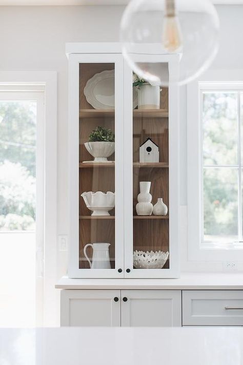 Stained oak shelves inside a glass-front china cabinet add a warm farmhouse touch styled with white ceramic decor. Glass Cabinets Display Ideas, Kitchen Glass Cabinets Display Ideas, Kitchen Glass Cabinets Display, Kitchen Glass Cabinet, Kitchen Glass Cabinets, Kitchen Cabinet Display, Glass Front Kitchen Cabinets, White China Cabinets, Warm Farmhouse