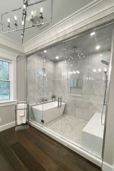 Effortlessly charming, this elegant primary bathroom by @amberhodorek featuring a #ThermaSol Steam Shower, white marble tile and rich hardwood floors is the perfect spa retreat. 🤍 | Thermasol | Thermasol Steam Shower | Thermasol Steam | Design Inspiration | Interior Design | Design Trends | Shower Trends | Shower Thoughts | Home Decor | Bathroom Decor | DIY Luxury Master Bathrooms, Full Bathroom Remodel, Bathroom Redesign, Master Bath Remodel, Bathroom Remodel Designs, Bathroom Remodel Shower, Dream House Rooms, Bathroom Design Luxury, Dream Bathrooms