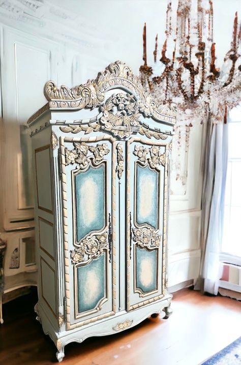 "SOLD.  DO NOT PURCHASE. Country french style armoire with black accents. Lightly distressed and aged to perfection with subtle gold highlights. This piece was lovingly handpainted in a calming light blue and \"antiqued\" for that old world feel. A pair of love birds and floral motifs top off her crown. 99H by 50W by 24D." Painted Secretary, Country French Style, Old Wardrobe, Dresser Wardrobe, French Painted Furniture, Armoire Dresser, Cottage French, French Country Shabby Chic, French Wardrobe