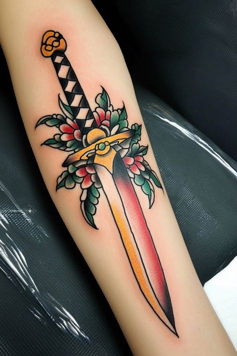 Traditional-style tattoo of a dagger with leaves and flowers on a person's forearm. Traditional Tattoos Forearm Women, Traditional Swords Tattoo, Aesthetic American Traditional Tattoos, American Traditional Tattoos Knife, 3 Of Swords Tattoo Traditional, Forearm Tattoo American Traditional, Traditional Tattoos With Words, Forearm Tattoo Women Traditional, American Tradional Tattoos