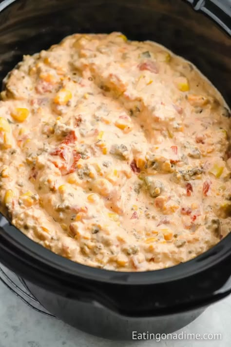 Crock Pot Cowboy Crack Dip is the perfect dip to serve for any occasion. You only need a few ingredients to make this flavorful dip. This spicy and creamy dip is a crowd favorite. It is perfect for large crowds and perfect for dipping your favorite tortilla chips in. #eatingonadime #crockpotcowboycrackdip #cowboycrackdip Mexican White Queso, Cream Cheese Rotel Dip, Cheese Rotel Dip, Sour Cream Chip Dip, Cream Cheese Rotel, Sausage Cream Cheese Dip, Sausage Dip Recipe, Bacon Wrapped Pickles, Sour Cream Chips