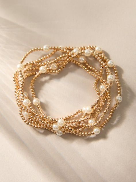 Stacking jewelry is a trend that will never go away, add to your bracelet collection with this set of gold and pearl stretch bracelets. Wear them together or pick and choose how many, these bracelets are dainty in design so they are cute on their own or powerful all together..#jewelrylover #handcraftedjewelry #jewelryinspiration #jewelrydesign #jewelryobsessed #jewelryoftheday #jewelrygoals #jewelryfashion #jewelrytrends Cheap Pearl White Pearl Bracelet With Round Beads, Trendy Small Beaded Bracelets, Cheap Dainty Pearl Bracelet With Round Beads, Bracelet Telephone Nude, Preppy Bracelets Pearl, Gold Bracelet For Women Modern, Roller Rabbit Bracelet, Dainty Bracelets Simple & Dainty Jewelry, Preppy Stack Bracelets