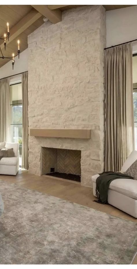 Stone Fireplace In Bedroom, Stone Faux Fireplace, Slurry Stone Fireplace, Arched Stone Fireplace, Stone Fireplace Between Two Windows, Beige Stone Fireplace Living Room, Creamy Stone Fireplace, Interior Stone Fireplace, Italian Fireplace Ideas