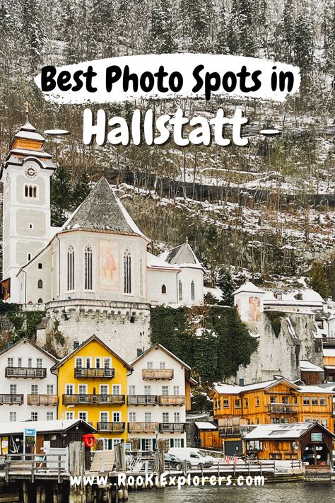 A serene view of Hallstatt from a ferry on the water. The mountainous terrain rises majestically in the background while the quaint, colorful buildings of the town line the shore. The text overlay reads "Best photo spots in Hallstatt. RooKiExplorers | Hallstatt | Winter | Mountain | Alps | Snow | Swans | Photospots | Instagram #Tips #Travel #Austria Hallstatt Austria Photo Ideas, Things To Do In Hallstatt Austria, Salzburg Photo Ideas, Hallstatt Photo Ideas, Hallstatt Austria Winter, Innsbruck Austria Winter, Hallstatt Christmas, Hallstatt Austria Photography, Hallstatt Winter