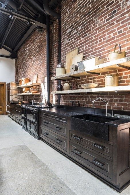 brick wall and dark finishes, concrete floor Black Kitchen With Concrete Floor, Loft Kitchen Design, Kitchen With Brick, Industrial Brick Wall, Dark Brick Wall, Inside Cabin, Brick Wall Kitchen, Warehouse Kitchen, Industrial Kitchen Design