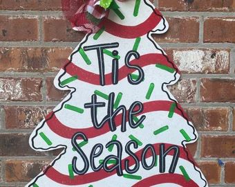 Christmas door signs | Etsy Little Debbie Christmas Cake Door Hanger, Christmas Wood Cutouts Yard Art Cut Outs, Wooden Christmas Trees Painted, Christmas Tree Wood Cutout, Christmas Tree Cake Painting, Little Debbie Christmas Tree Door Hanger, Little Debbie Christmas Tree Cakes Decor, Christmas Tree Signs Wood, Christmas Tree Door Hangers