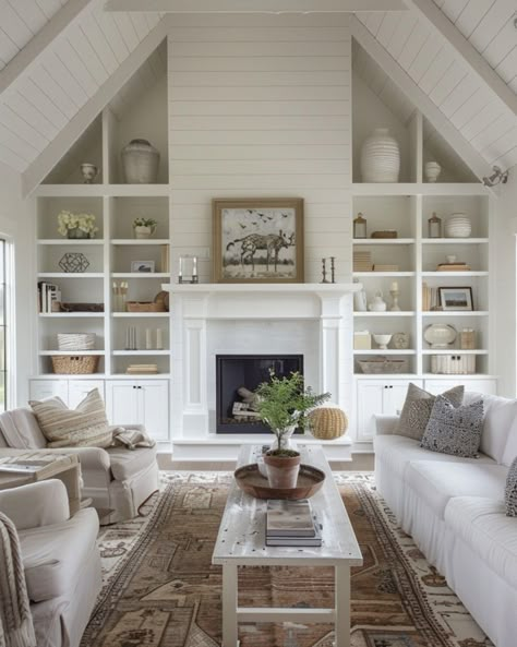 This living room totally captures the modern farmhouse vibe I love! With its vaulted ceilings and shiplap walls, it feels open and airy, but still super cozy. The built-in shelves around the fireplace? Such a great way to add a personal touch with your favorite decor, while keeping everything organized. I’m all about the mix of soft neutrals and textured accents that give the space warmth without feeling cluttered. Plus, with those big windows letting in all that natural light, it’s the perfe... Built Ins Around Fireplace Cathedral Ceiling, Fireplace In Vaulted Ceiling, Family Room Vaulted Ceiling, Vaulted Ceiling Living Room Built Ins, Sloped Living Room Ceiling, Living Room Built Ins With Vaulted Ceiling, Vaulted Ceiling Shelves, Great Room Fireplace Vaulted Ceilings With Built Ins, White Walls With Brown Trim