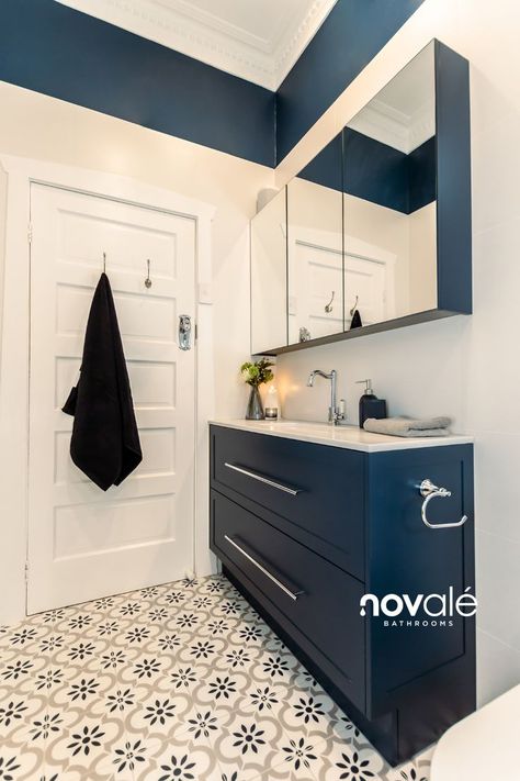 Few colour combinations pop quite like crisp white and navy blue! The chrome fixtures, white wall tiles, and white vanity top contrast beautifully with the dark navy vanity front and the Dulux wall paint. To tie in both colours of this exquisite design, the feature floor tiles lends a classic, almost preppy energy. Navy And Chrome Bathroom, Navy Vanity, Bespoke Bathroom, White Wall Tiles, Chrome Fixtures, Chrome Bathroom, White Vanity, Colour Combinations, Vanity Top