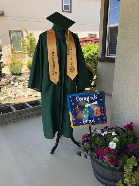 Graduation decor cap and gown Graduation Gown Display, How To Display Graduation Cap And Gown, Graduation Green Cap And Gown, Graduation Cap And Gown Display, Green Graduation Gown And Cap, Cap And Gown Display For Party, Green Graduation Gown, Graduation Party Candy Bar, Green Graduation Cap