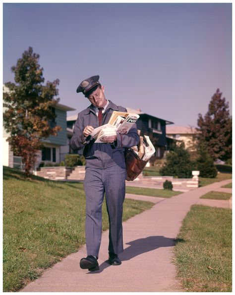 Postman Delivering Mail Suburban Neighborhood Sorting Letters Walking On Sidewalk 1964 Photo H. Armstrong Roberts Suburban Neighborhood, Radium Girls, Mail Man, Mail Bag, Going Postal, Light Film, Postal Worker, Us Postal Service, Terry Pratchett