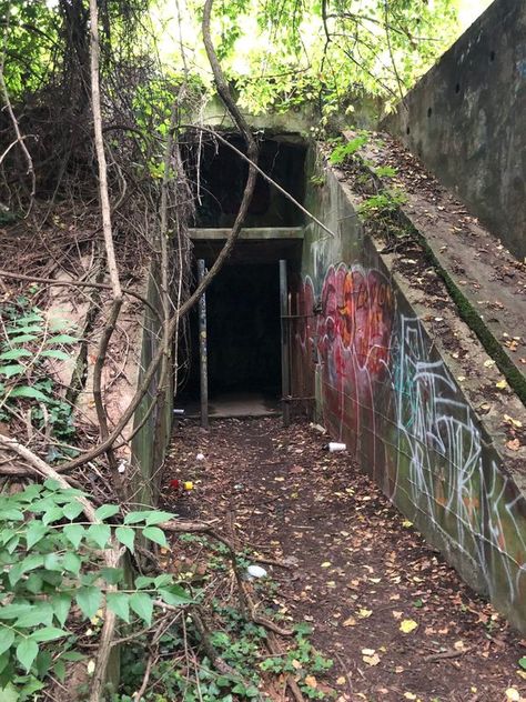 An eerie, abandoned military base engulfed by nature and graffiti is now home to a local park. Illustration Storyboard, Eyes Horror, Gothic Landscape, Apocalyptic City, Post Apocalyptic City, The Anomaly, Military Bunkers, Secret Lab, Old Abandoned Buildings