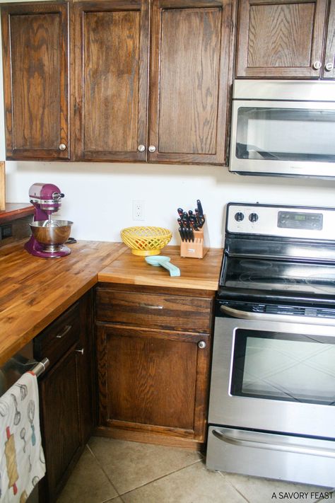 Butcher Block Countertops: My experience after six months, including initial maintenance and everyday use and care. Butcherblock Countertop With Oak Cabinets, Butcher Block Countertops On Wood Cabinets, Wood Kitchen Cabinets With Butcher Block, Butcher Block Countertops With Natural Wood Cabinets, Butcher Block With Wood Cabinets, Butcher Block Countertops Brown Cabinets, Stained Cabinets With Butcher Block, Dark Green Kitchen Cabinets With Butcher Block Countertops, Wood Cabinets With Butcher Block Counter