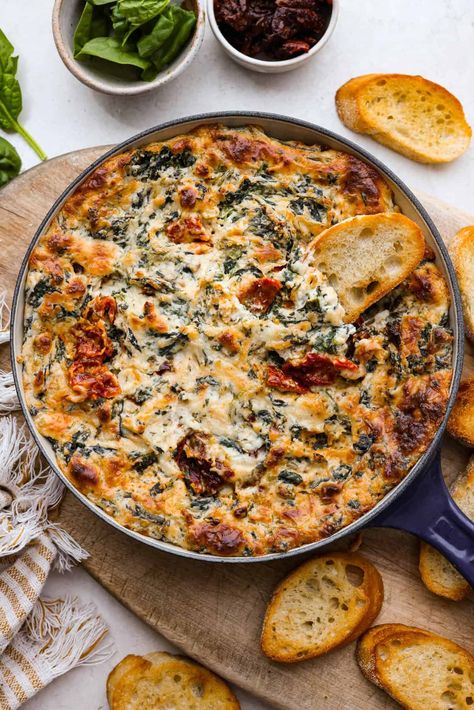 There's a new appetizer in town, and this creamy Tuscan dip won everyone's hearts! The combination of cheeses, garlic, spinach, and sun-dried tomatoes creates an addicting dip you’ll want to bring to all of your gatherings! Appiterzer Dips, Party Apps Finger Foods, Tuscany Appetizers, Sun Dried Tomato Appetizer Recipes, Olive Tapenade Appetizers, Good Side Dishes To Bring To A Party, Football Side Dishes, Sunday Funday Dip, Mediterranean Appetizers Appetizer Ideas