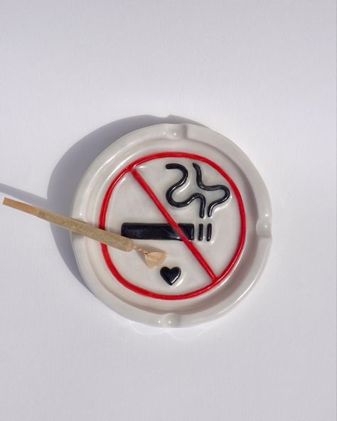 no smoking sign quirky ceramic ash tray, hand built, hand made and  hand painted in the UK. The ideal ashtray to complete your bad girl/ 420 stoner girl aesthetic. Also the perfect handmade gift for any stoner bestie. Find this functional art piece and more on sicalimited.com Functional Hand Built Pottery, Midnight Gospel Ashtray, Stone Clay Art, Clay Ashtray For Boyfriend, Ceramic Boyfriend Gifts, Ceramic Art Ash Tray, Pottery Painting Ash Tray, Clay Ash Trays Aesthetic, Ashtray Made Of Clay