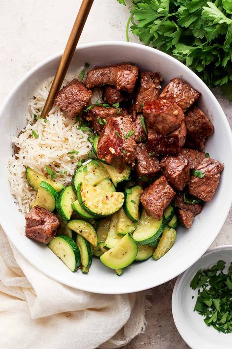 Garlic Butter Steak Bites - A delicious and easy Garlic Butter Steak Bites recipe that is packed with flavor and comes together in just 30 minutes! #garlicbuttersteakbites #garlicbuttersteakbitesrecipe #garlicbuttersteakbiteswithzucchini #steakbiteswithgarlicbutter Healthy Steak Tip Recipes, Easy Healthy Steak Recipes, Easy Meals With Steak, Steak Tips Meal Prep, Easy Steak And Rice Recipes, Balanced Lunches For Work, Healthy Recipes Steak, Steak Zucchini Recipes, Clean Easy Dinner Recipes