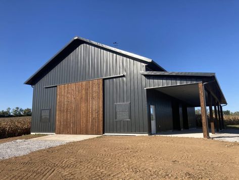 Black Pole Barns, Plans For 2023, Pole Building Garage, Wooden Sliding Door, Pole Barn Shop, Diy Pole Barn, Metal Pole Barns, Metal Garage Buildings, Pole Barn Plans