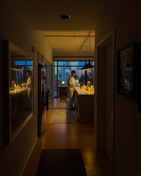 A cozy evening scene with warm lighting, prepping in a modern kitchen while the city skyline glows in the background—perfect blend of calm and urban vibes. Ambient Lighting Kitchen, Nyc Kitchen Apartment, Ambient Lighting Living Room, Fluffy Chair, Evening Aesthetic, Nyc Kitchen, Lighting Living Room, San Francisco Houses, Living Place