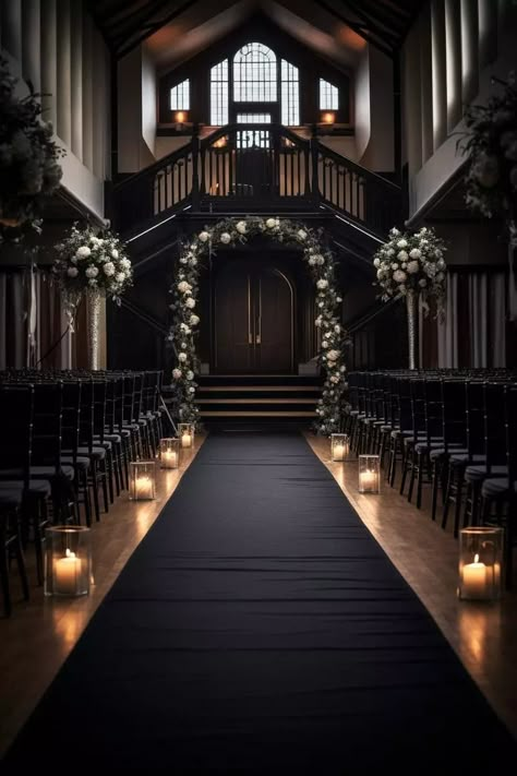 Dimly lit wedding aisle with a dark runner leading to an ornate arched door, adorned with white flowers and greenery. Glass candle holders with lit candles line both sides of the aisle, creating a warm, romantic ambiance. Black Wedding Styles, Wedding Dark Aesthetic Ceremony Decor, Dark And Elegant Wedding, All Black Wedding Ceremony Decor, Black Theme Weddings, Wedding Themes With Black, Mafia Wedding Decor, Gothic Wedding Ideas Victorian, Black Wedding Venue Aesthetic