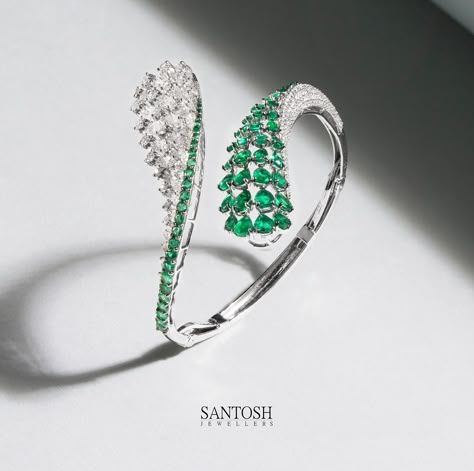 This gorgeously crafted bangle, embellished with the finest diamonds and emeralds, weaves a tale of artistry and sophistication. Each delicate curve whispers secrets of impeccable design and craftsmanship. A radiant beacon of beauty that deserves to be cherished. #JewelryArtistry #DiamondsAndEmeralds #ElegancePersonified #middleeast #santoshjewellers #jewelerygram #diamonds #jewels #jewelsofinstagram #uaejewellery #finejewellery #jewellerydesign #uae #middleeast #doha #dubai🇦🇪 #qutar Bracelet Jewelry Design, Breslate Design, Female Rings, Silver Bracelet Designs, Oval Bangle, Beautiful Jewelry Diamonds, Jewellery Photography Inspiration, Neck Pieces Jewelry, Diamond Choker Necklace