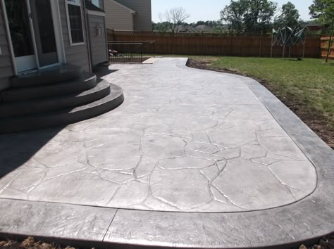 Concrete Patio Front Of House, Stamped Patio With Border, Stamped Concrete Patio With Border, Limestone Stamped Concrete, Wrap Around Concrete Patio, Stamped Concrete Patio Shapes, Front Yard Concrete Patio Ideas, Stamped Concrete With Border, Simple Stamped Concrete Patio