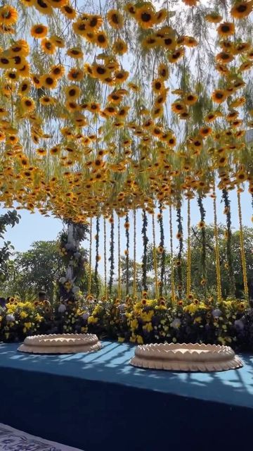 WeddingBazaar on Instagram: "Sunflower themed #haldiceremony decor ✨🌻 . . Bride - @loukreddyb Groom - @nikhillb18 Design & Decor - @juetahemdev Wedding planner - @yoloentertainmentofficial Venue - @rafflesudaipur Florist - @mybagiya Props & Candles - @shinecollectionbydeepaksharma Video 1 - @reelsandframes . . . Download @weddingbazaarofficial’s free App & explore curated ideas, plan weddings and book vendors all in one place! #LinkInBio 💕 . . . . #weddingbazaar #indianwedding #haldidecor #haldidecoration #haldidecorationideas #haldidecorideas" Haldi Venue Decor, Sunflower Theme Haldi Decor, Sunflower Decor Wedding, Sunflower Haldi Decor, Haldi Theme Ideas, Haldi Ceremony Decorations Indoor, Sunflowers Decorations, Traditional Indian Wedding Decor, Haldi Theme