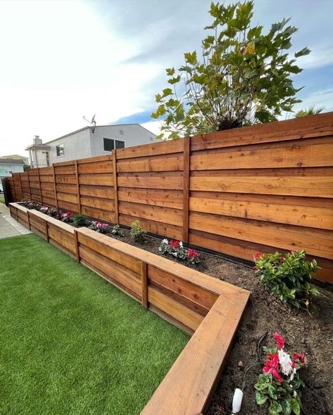 Built planter boxes along the fence line to create a beautiful and functional garden space. The planter boxes will not only add visual appeal to the fence line but also provide an opportunity to grow a variety of flowers. Planter boxes from @glscapes Backyard Raised Planter Ideas Along Fence, Flower Box Along Fence, Long Flower Boxes Planters, Fence With Garden Boxes, Back Fence Garden Ideas, Planter Boxes On House, Planter Along Fence Line, Fence With Hanging Plants, Planter Against Fence