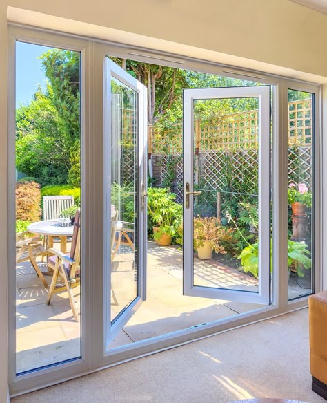 French patio doors with side windows can transform your living space with more natural light.. Backyard Double Doors, French Doors From Bedroom To Patio, Replacing Sliding Door With French Doors Patio, Patio With French Doors, Large French Doors Patio, Folding Patio Doors With Screen, Backyard French Doors, Large Glass Doors To Patio, Bedroom With French Doors To Patio