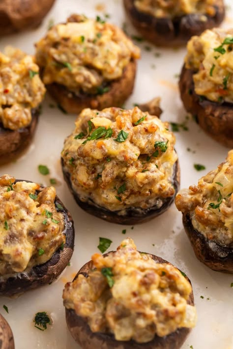 Pass a good time (and some good food) with these party-ready sausage stuffed mushrooms! Greet your guests with a tray of savory, creamy, bite-sized hors d'oeuvres that feel elegant and elevated, but are super easy to make. You might want to be ready with a second tray, though. They disappear fast! Sausage Stuffed Mushrooms Ina Garten, Whole 30 Stuffed Mushrooms, Sausage And Cheese Stuffed Mushrooms, Fancy Stuffed Mushrooms, Stuffed Mushrooms With Goat Cheese, Stuffed Mushrooms With Sausage Easy, Easy Stuffed Mushrooms Sausage, Stuffed Mushroom Recipes Sausage, Stuffed Sausage Mushrooms