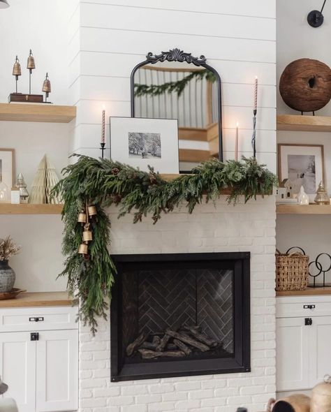 We're sharing 17 Christmas mantel decor ideas you will love! Neutral and colorful, simple and extravagant we have you covered with decor ideas for the holiday season! Simple Christmas Garland Mantle, Fireplace Winter Decor, Modern Farmhouse Christmas Mantle, Corner Fireplace Christmas Decor, Fireplace Mantle Greenery, Christmas Garland Fireplace Mantle Ideas, Modern Christmas Fireplace, Modern Christmas Mantle Decor, Christmas Fireplace Mantel Decor