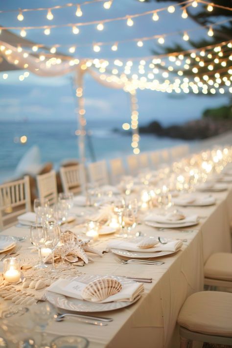 Beach wedding reception. Long, cream-colored tables with sea-shell centerpieces under twinkling fairy lights.

Stunning ocean vistas, breezy cliffside beauty, the nautical charm of seashore treasures; coastal weddings have a magical allure of their own. If you're planning on saying 'I do' amidst the intoxicating salt-kissed air, then these 25 coastal wedding reception décor ideas are definitely a wave worth riding. From mesmerizing marine-inspired…

Read more: https://tastywed.com/25-coastal-wedding-reception-decor/ Beach Fairy Lights Wedding, Beach Table Setting Wedding, Beach Dinner Table Decor, Chic Beach Party Decor, Elegant Coastal Wedding Decor, Beach Wedding Celebration, Wedding Decorations Beach Theme, Beach Wedding Table Set Up, Beach Wedding Round Table Decor