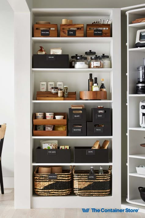 From sustainably-made shelf organizers and bins to food canisters and labels, The Container Store has everything you need to keep your kitchen organized! Shop our collection here! Home Goods Organization, Pantry Bottle Organization, High End Pantry Organization, Tea Pantry Organization, Container Store Pantry Organization, Pantry Storage Bins, Gold Pantry Organization, Black And Wood Pantry Organization, Dinnerware Organization Cabinets