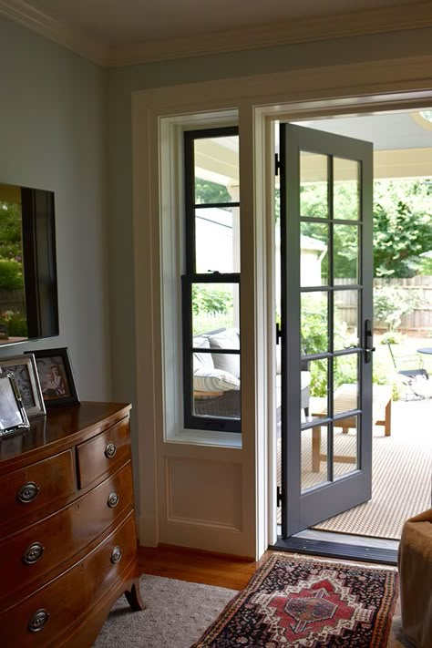 Two skinny double-hung windows on either side of the patio door allow light and style into the space. Sliding Glass Door Front Of House, Sliding Porch Doors, Window And Door Designs, Window Beside Door, Multiple French Doors On Front Of House, French Doors From Bedroom To Patio, Glass Exterior Door In Kitchen, Bedroom Door With Window, Patio Door And Window Combination