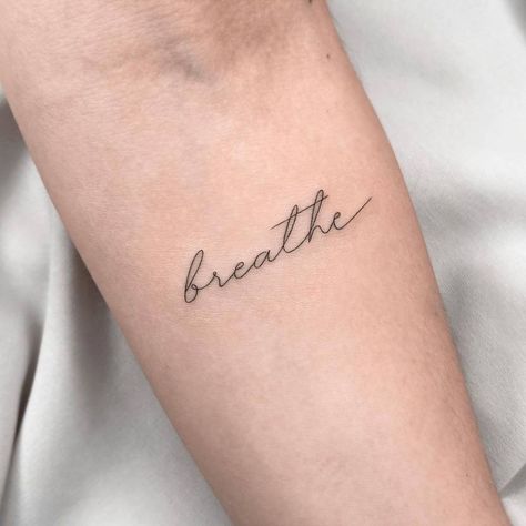 "Breathe" lettering tattoo on the inner forearm. Breathe Tattoos For Women, Just Breathe Tattoos, Just Breathe Tattoos For Women, Tattoos For Women Forearm, Forearm Word Tattoo, Relax Tattoo, Breathe Tattoos, Just Breathe Tattoo, Wrist Tattoos Words