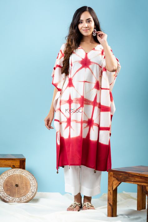 Time to elevate your daily outings with the exquisite craftsmanship of Indian tie-dye Print. The line pattern print with natural dyes elevates the old-world charm of this Kaftan. The 100% premium cotton coupled with the relaxed fit of the Kaftan promises unparalleled comfort all day long. Tied at the waist, it gives you a beautiful shape, so you stay stylish even while lounging. The neckline comes with mirror highlights and handkantha work hangs. Kaftan Style, Kurta Dress, Cotton Kaftan, Ladies Wear, Line Pattern, Tie Dye Designs, Womens Clothing Stores, Daily Essentials, Tie Dye Print