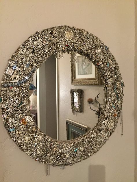 "Spectacular one-of-a-kind wall mirror created from thousands of pieces of authentic vintage rhinestone jewelry and other embellishments. I collected each jewelry piece over a period of 20 years and it took several years to finalize the arrangement of each and every item. Truly a labor of love and the end result is stunning!   *30\" diameter overall   *4\" wide frame   *20pounds   *hangs from single hanger Price reduced 11/22/2020." Vintage Mirror Wall Decor, Glam Mirror, Old Jewelry Crafts, Jewelry Frames, Vintage Rhinestone Jewelry, Jewelry Christmas Tree, Vintage Mirror Wall, Junk Jewelry, Fashion Mirror