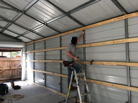 Storage In Metal Building, Shelves In Metal Building, Metal Building Shelving Ideas, Metal Building Man Cave Ideas, Carport Shop Ideas, Framing Inside Metal Building, Metal Building Ideas Garages, Metal Garage Workshop, Metal Building Workshop Ideas