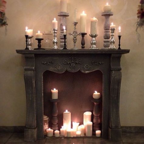 a vintage fireplace with pillar candles and vintage candle holders in the fireplace and on the mantel Mantel Candles, Gothic Fireplace, Evil Lair, Faux Fireplace Diy, Vintage Fireplace, Candles In Fireplace, Faux Fireplace, Candle Displays, Diy Fireplace