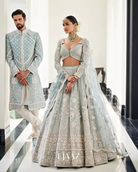 Bride Story on Instagram: “The dreamy icy blue lehenga and sherwani is the ideal assortment of modern elegance and a timeless tale for summertime soirée. All the…��” Bride And Groom Indian Wedding Outfit Pastel, Indian Bride Wedding Dress, Day Wedding Outfit Indian, Engagement Lehengas For Bride, Interracial Indian Wedding, Bridal Reception Dress Indian, Indian Wedding Couple Outfits, Engagement Outfits For Bride, Bride And Groom Indian Wedding Outfit