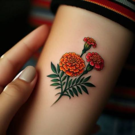 69 Outstanding And Meaningful Marigold Tattoo Ideas With Rays Of Hope! Orange Chrysanthemum Tattoo, Marigold Black And White Tattoo, Marigold Hand Tattoo, Merigold Aesthetic Flower Tattoo, Marigold And Cosmos Tattoo, Simple Marigold Tattoo, Mexican Flower Tattoo, Mexican Culture Tattoo For Women, Marigold Tattoo Design