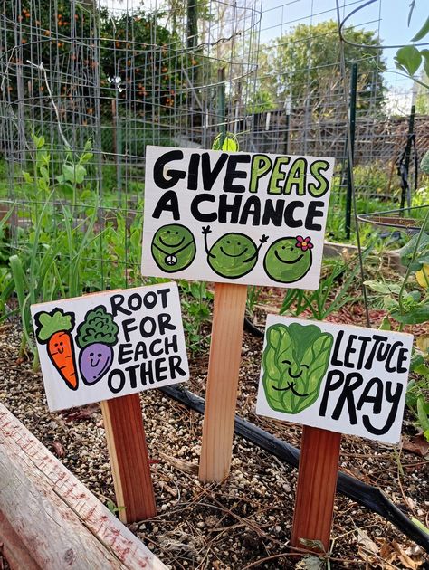 This playful garden set features three charming signs. The "Give Peas a Chance" sign stands at 17 inches tall, while the "Root for Each Other" and "Lettuce Pray" signs are each 12 inches tall. Crafted from solid wood, these signs are hand-painted and weather-sealed, making them perfect for adding a touch of whimsy to a children's garden or any vegetable or herb garden. Their humorous and cute design brings a splash of color to your outdoor space. Explore more vegetable garden signs at the provided Etsy link. Each item is made to order, ensuring a unique and personal touch. Vegetable Garden Signs, Landscaping Aesthetic, Give Peas A Chance, Backyard Homestead, Patio Design Ideas, Gifts For Gardeners, Sensory Garden, Kids Garden, Market Garden