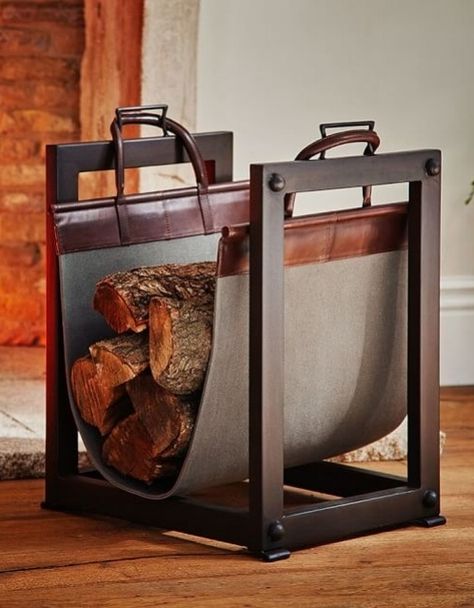 A sturdy iron frame and canvas-and-leather sling on Pottery Barn';s Industrial log carrier/holder make it both handsome and functional | archdigest.com Industrial Fireplace, Indoor Firewood Rack, Firewood Storage Indoor, Log Carrier, Classic Fireplace, Firewood Holder, Fireplace Logs, Small Fireplace, Log Baskets