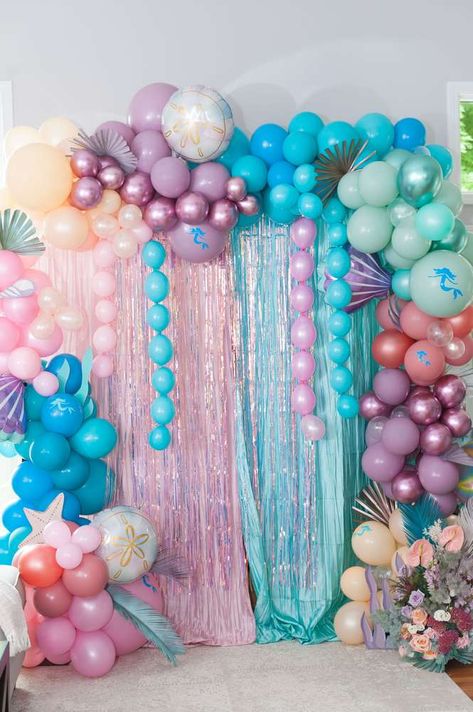 Sophia's Magical Mermaid 4th Birthday Pool Party | CatchMyParty.com Mermaid Birthday Party Balloon Arch, Mermaid Party Photo Backdrop, Dive Into 5 Mermaid Party, Infinity Decorations, Rainbow Mermaid Birthday Party, Mermaid Backdrop Ideas, Mermaid Barbie Birthday Party, Mermaid Pool Party Ideas, Barbie Mermaid Birthday Party