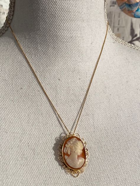 Estate Fresh ! This is a beautiful and elegant 12k Fill Cameo Pendant Brooch Necklace. 12k Chain is stamped on Novelty Vintage Clasp and Cameo is stamped on back inside setting. She is a right facing Victorian Lady Hand Carved From Shell. The Gold setting has a dainty border which makes a heart at the top and bottom. She is cold to the touch has has the curve of the Shell. This is a vintage estate item therefore they may show some wear or imperfections adding to the character & authenticity. Cameo Necklace Aesthetic, Scorpio Necklace, Grandma Vintage, Rhinestone Jewelry Set, Pendant Brooch, Victorian Lady, Vintage Cameo, Bracelet Earring Set, Carved Shell