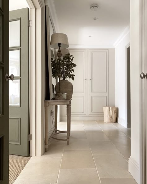 This spacious modern entryway showcases beautiful limestone floor tiles. The use of a neutral color theme with sage green elements creates a sense of tranquility. Decorate the entryway with plant dÃ©cor to complement the color scheme. Entrance Flooring, Hallway Tiles Floor, Hall Tiles, Limestone Floor, Limestone Floor Tiles, Floor Tiles Design, Tile Floor Living Room, Tiles Designs, Hall Flooring