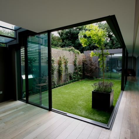 Glass extensions, open plan living spaces and large #glazinginstallations are all designed to create beautifully light interiors and a greater connection to the outdoors. Recently, architects are choosing to include an internal glass #courtyard in their projects, like this one surrounded by minimal windows #slidingdoors. #slimslidingdoors #aluminiumsliders #minimalwindows #residentialarchitecture #slimsliders #glassextension #glasscourtyard #internalcourtyard Indoor Courtyard, Courtyard Design, Internal Courtyard, Glass Walls, Patio Interior, Courtyard House, Interior Garden, Design Exterior, House Extensions